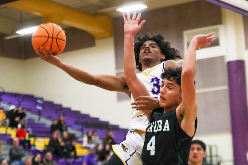 Lemoore's Kobe Green eyes the basket in Wednesday night win over league rival Dinuba. 
